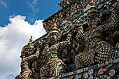 Bangkok Wat Arun - Statues of the mythical  demon bears  that support the different levels of the prang.
